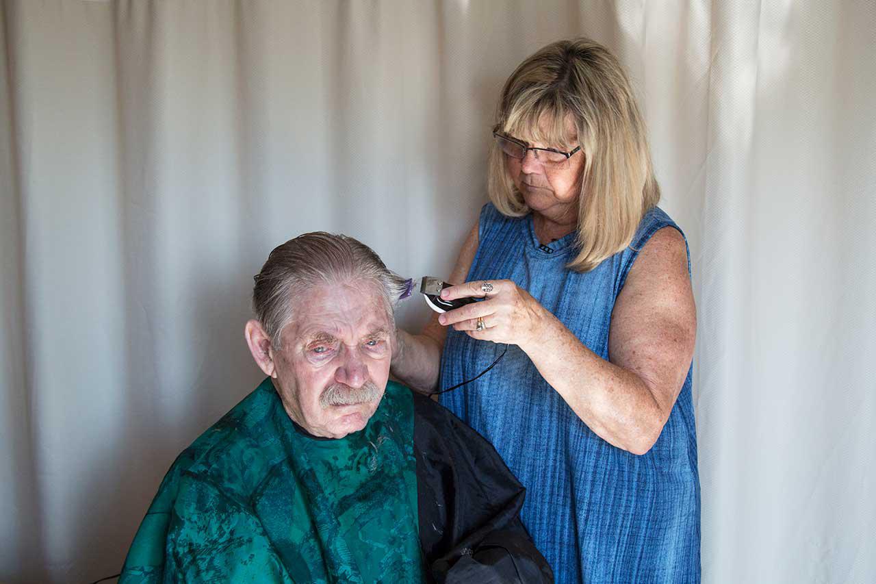 Allen Wagner, 79, having his hair cut by his wife, Charlene, in his room at a nursing home in Overland Park, Kansas, July 27, 2017.