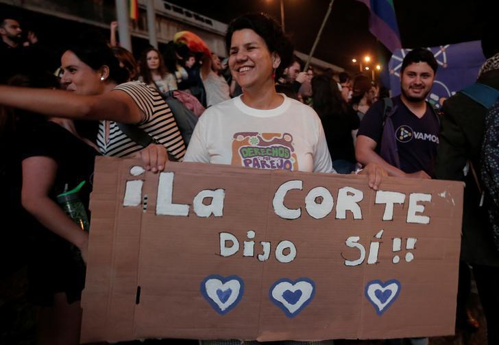 People celebrate after the Inter-American Court of Human Rights called on Costa Rica and Latin America to recognize equal marriage, in San Jose, Costa Rica, January 9, 2018. The sign reads: "The court said yes". 