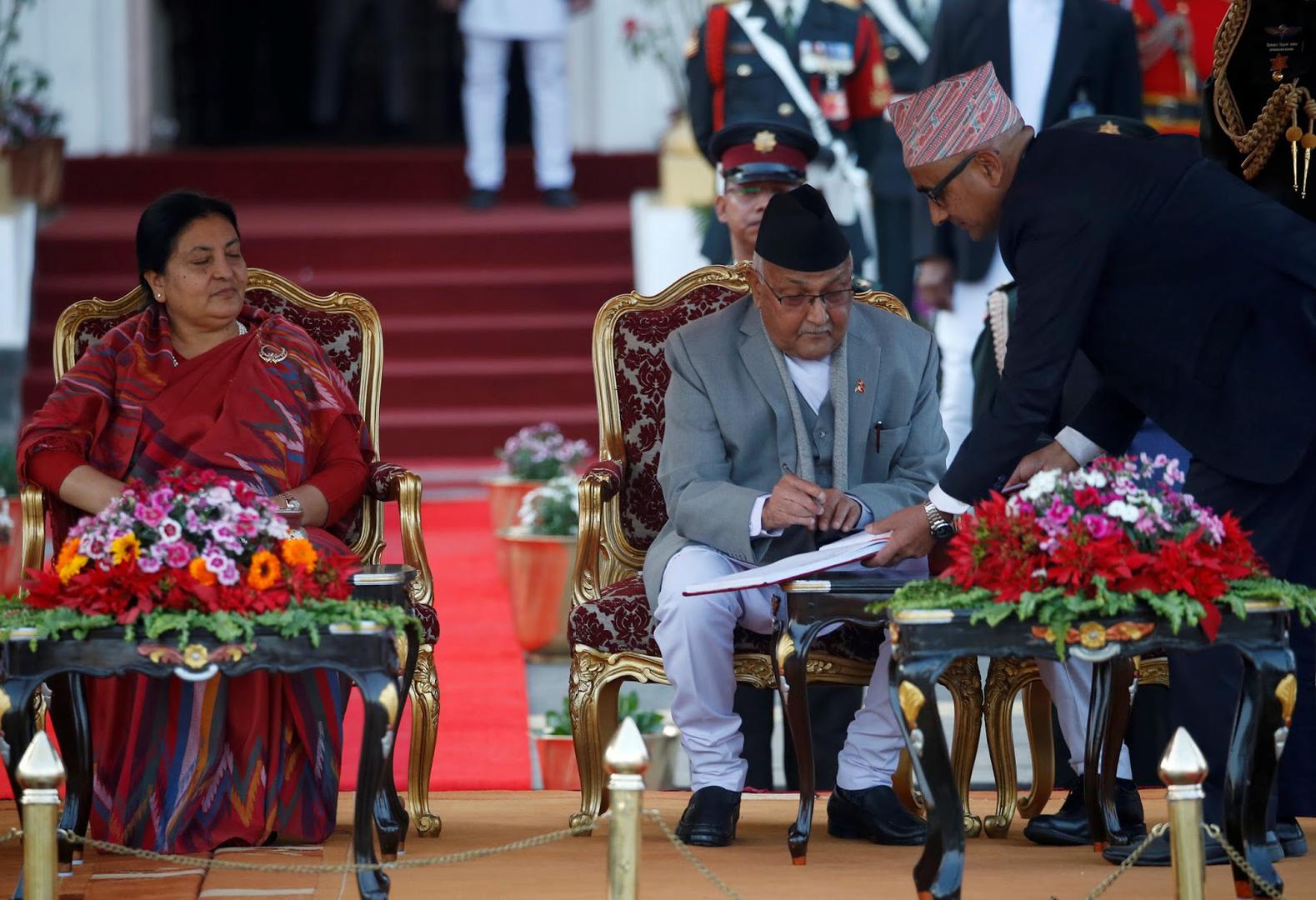 Nepal’s Prime Minister Khadga Prasad Oli signs the oath of office papers next to President Bidhya Devi Bhandari in Kathmandu, Nepal, February 15, 2018.