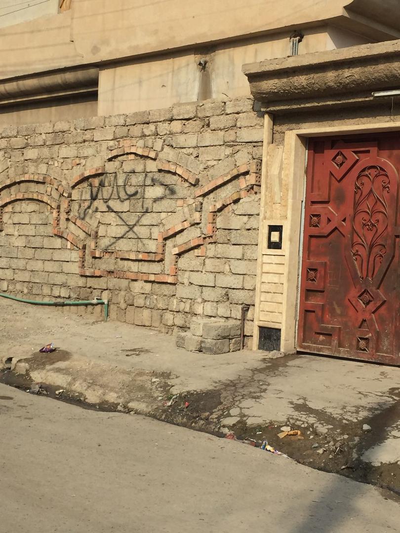 Graffiti that reads "Daesh (ISIS)," marks the home of relatives of an ISIS member in a west Mosul neighborhood, Iraq. © 2018 Private.