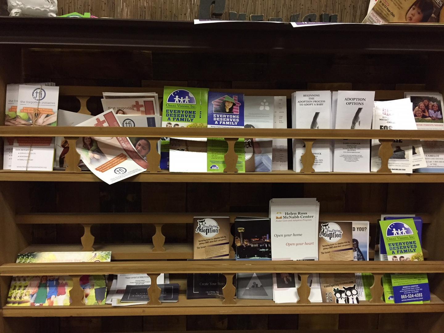 A display of brochures for adoption and foster care in Knoxville, Tennessee.