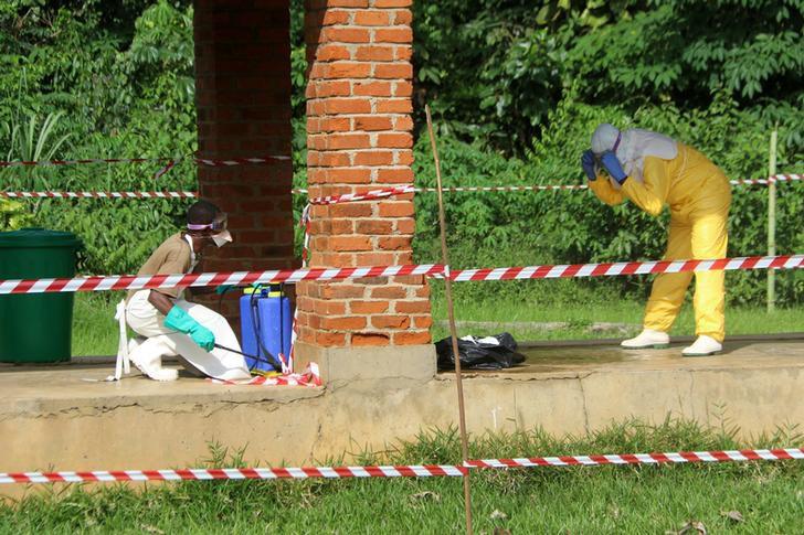 A Congolese health worker is sprayed with chlorine after visiting the isolation ward at Bikoro hospital, which received a new suspected Ebola case, in Bikoro, Democratic Republic of Congo, May 12, 2018.