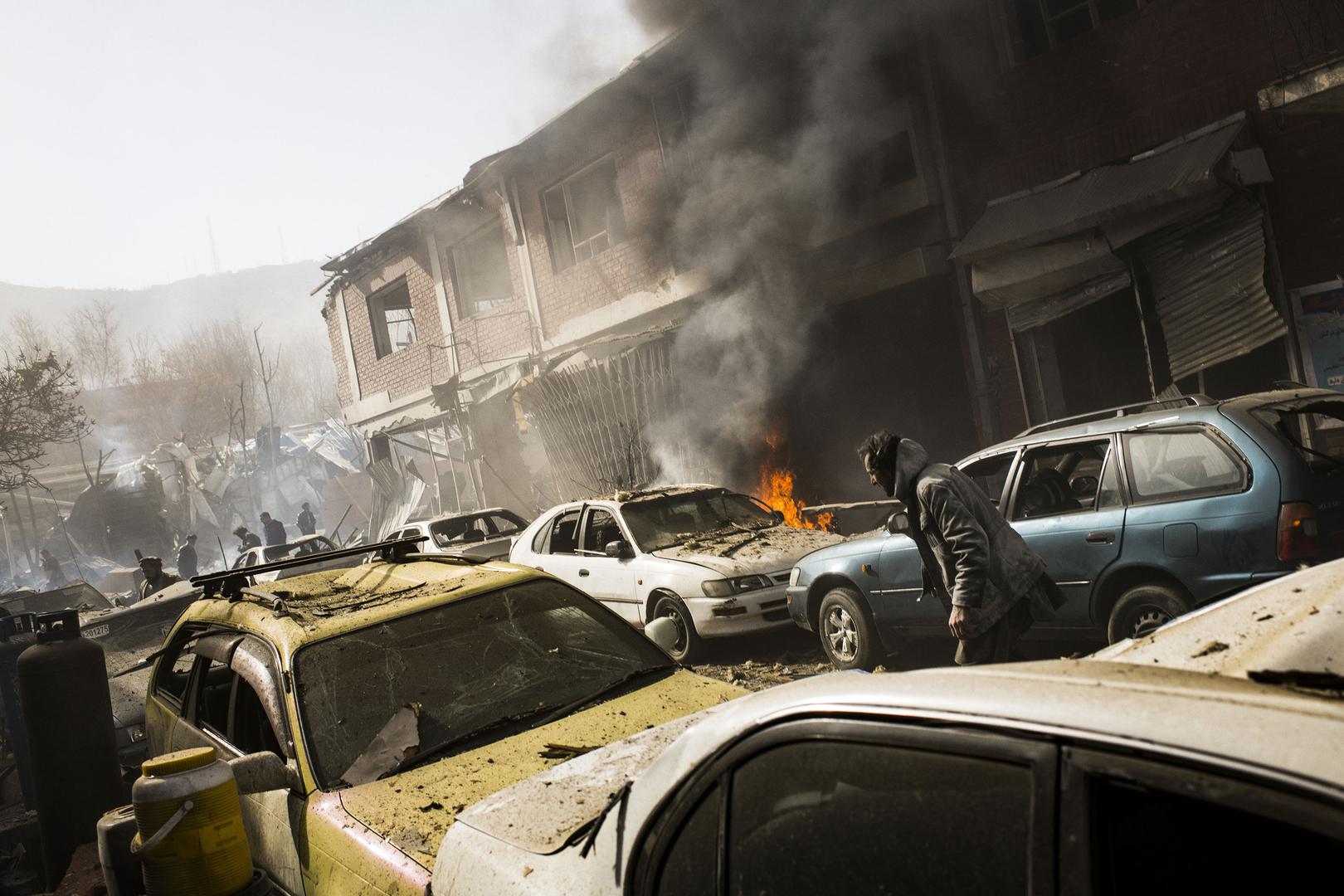 Smoke rises from damage on an adjacent street after the ambulance bomb in central Kabul, January 27, 2018.