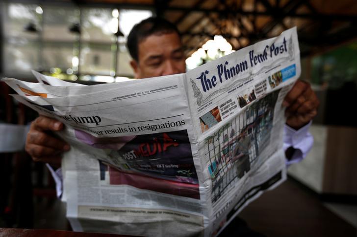 A man reads the Phnom Penh Post at a coffee shop in Phnom Penh, Cambodia, May 8, 2018.