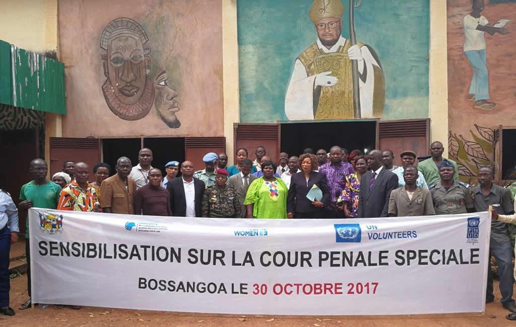 Participants pose with a banner commemorating an outreach workshop on the Special Criminal Court in Bossangoa, Ouham Prefecture, in the Central African Republic on October 30, 2017. © 2017 Special Criminal Court