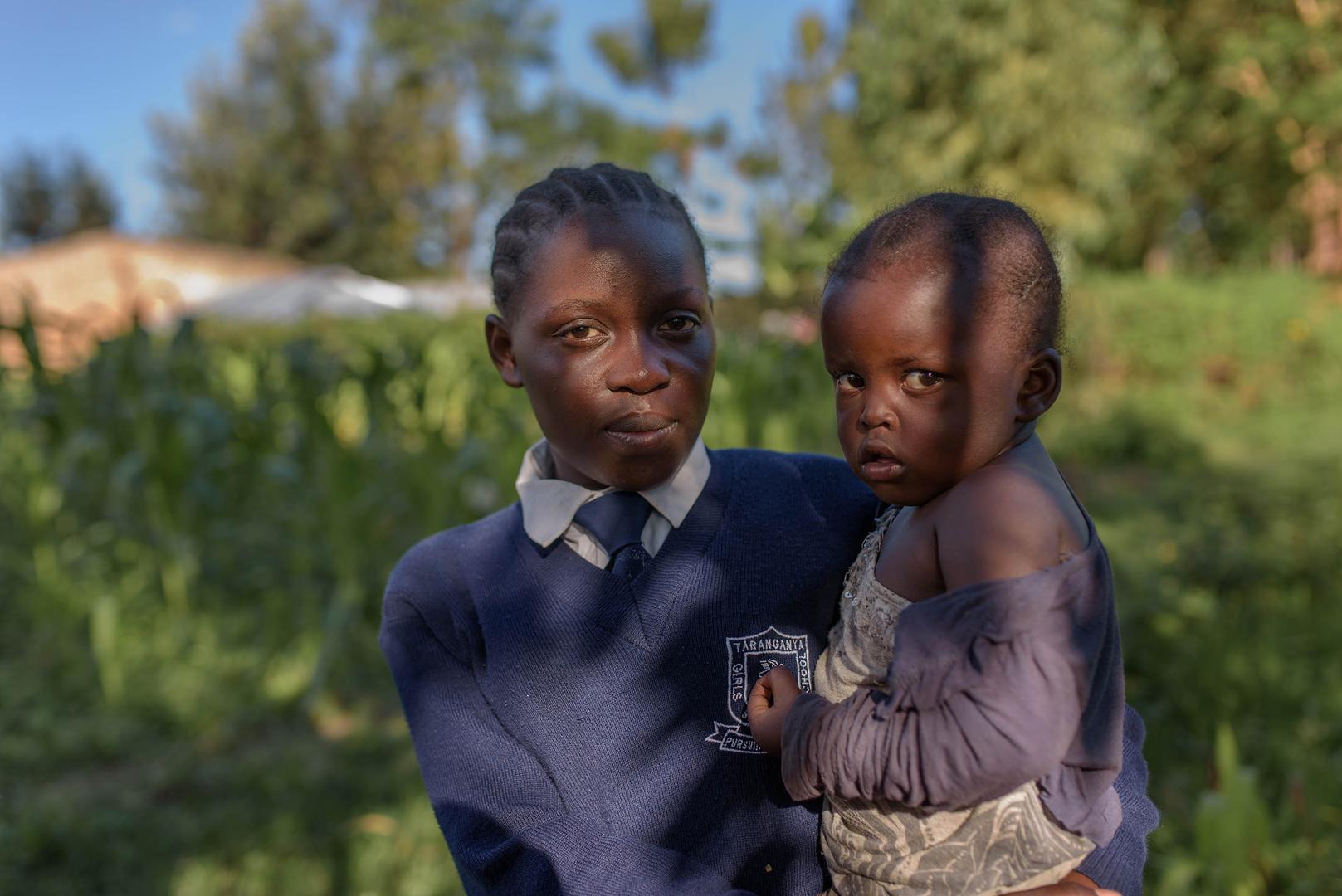 “Evelina,” 17, with her 3-year-old daughter “Hope,” in Migori county, western Kenya. Evelina is in Form 2, the second year of lower secondary school. 