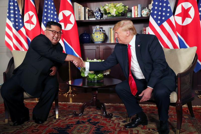 U.S. President Donald Trump shakes hands with North Korea's leader Kim Jong Un before their bilateral meeting at the Capella Hotel on Sentosa island in Singapore June 12, 2018.