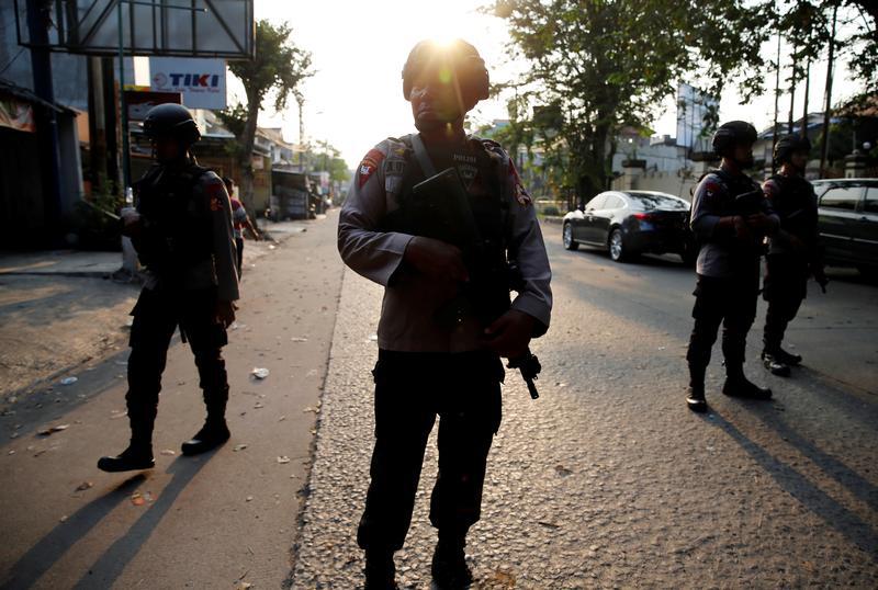 A group of mobile brigade policemen patrols near the Mobile Police Brigade (Brimob) headquarters in Depok, south of Jakarta, Indonesia, May 9, 2018.