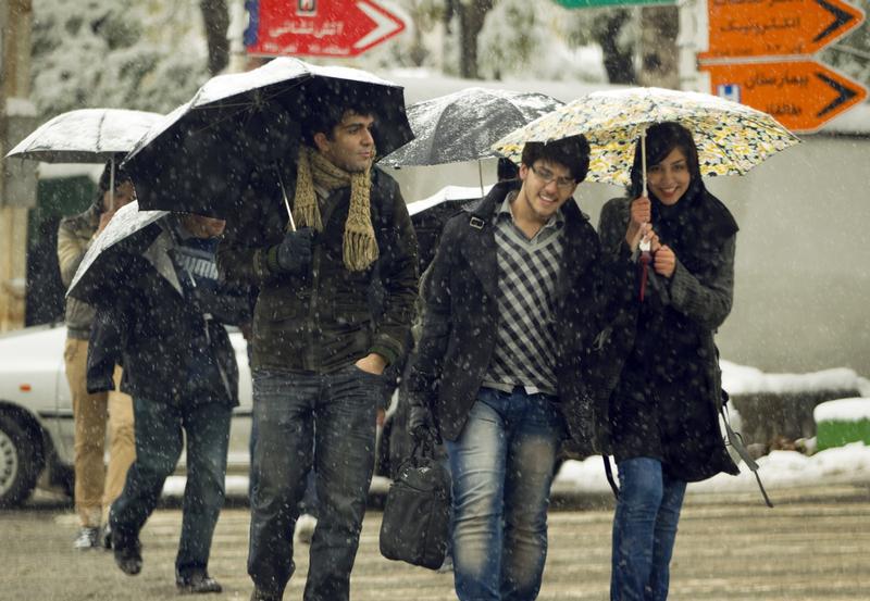 一群大学生冒著暴风雪过街，德黑兰，2010年11月8日。 