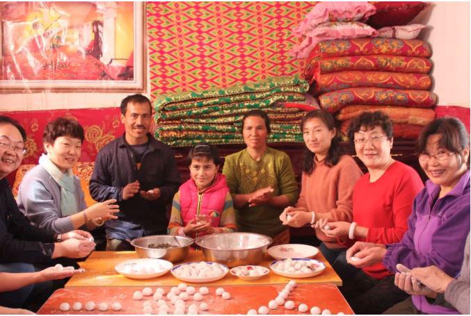 A State press photo showing Chinese officials staying with Turkic Muslim families during compulsory homestay “Becoming Family” program in Xinjiang. 