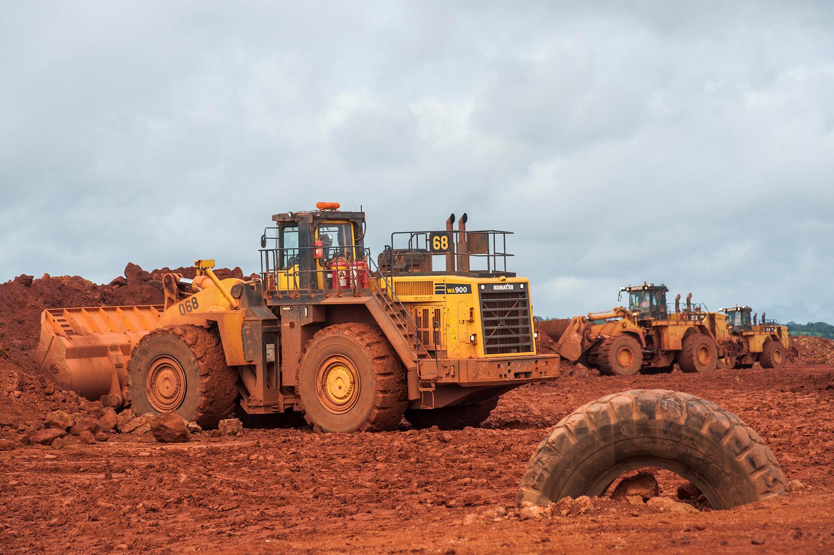 Bulldozers move bauxite at the Sangaredi mine operated by Compagnie des Bauxites de Guinée (CBG) near Boké, Guinea on September 8, 2015. 