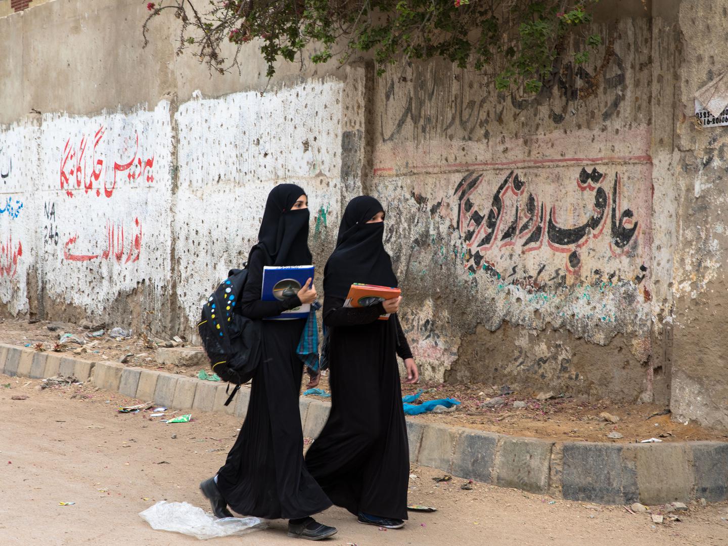 Students walk to school in Behar colony of Karachi. 