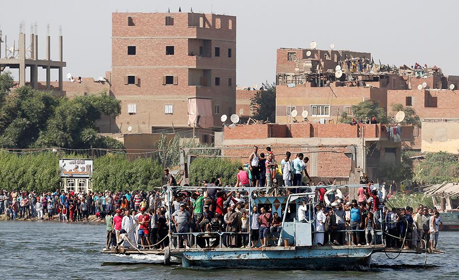 Egyptians shout slogans against the government while on a ferry during the funeral of Syed Tafshan, who died in clashes with residents of the Nile island of al-Warraq island, when security forces attempted to demolish illegal buildings, in the south of Ca
