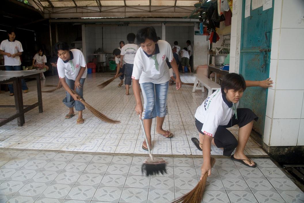 In Malang, Indonesia, prospective domestic workers clean the facilities of their training center prior to migrating for employment in Singapore, Hong Kong, and Taiwan.