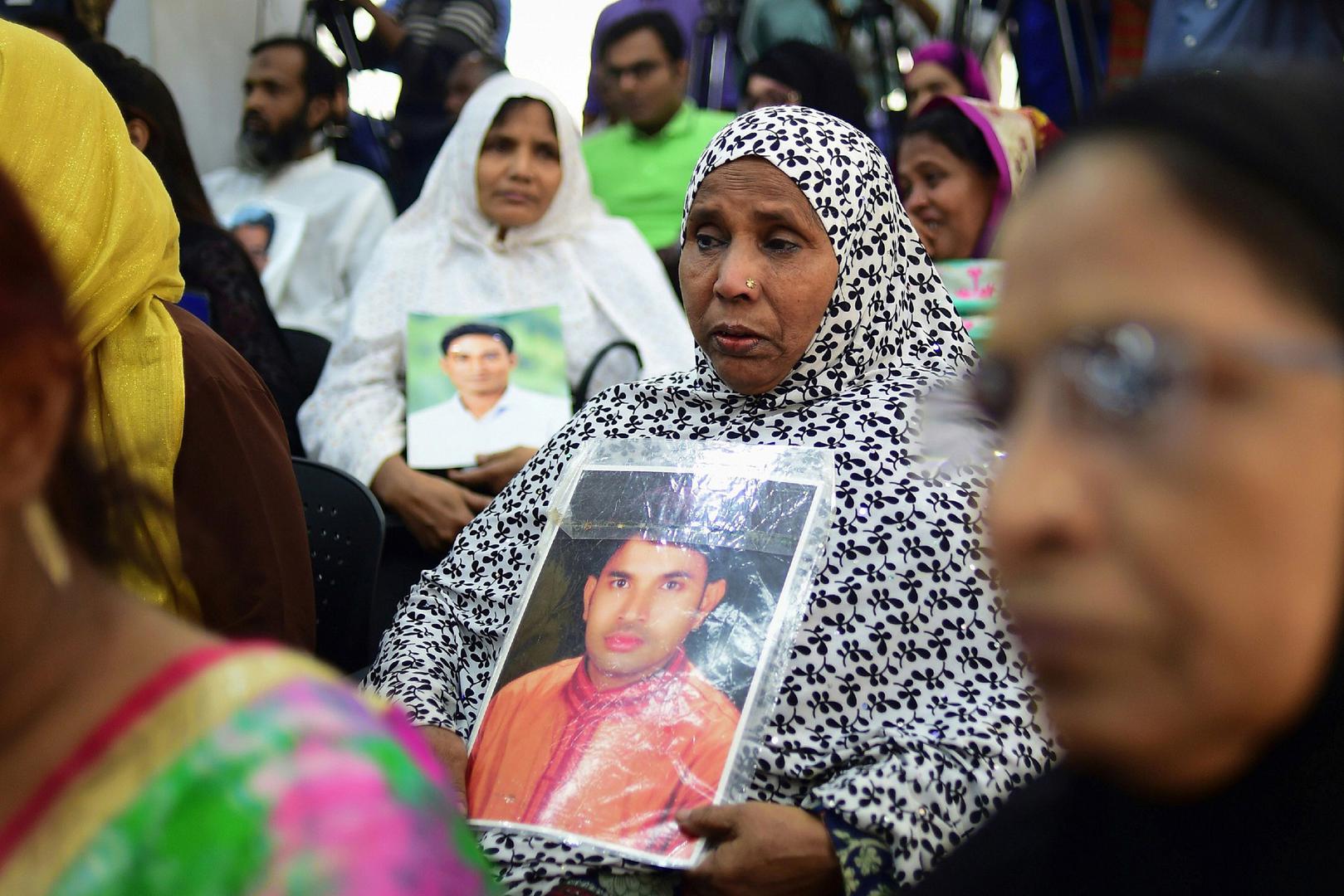 Bangladeshis hold photos of missing relatives during a press meeting in Dhaka on December 4, 2018.  Hundreds joined in the protest demanding justice for the victims. © 2018 Munir UZ ZAMAN / AFP/ Getty Images