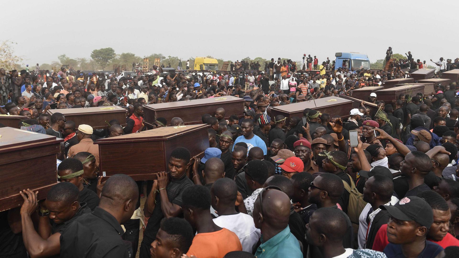 Pallbearers carry coffins during the funeral service for people killed during clashes between cattle herders and farmers in Ibrahim Babangida Square in the Benue state capital, Makurdi, January 11, 2018. Violence between the mainly Muslim Fulani herdsmen 
