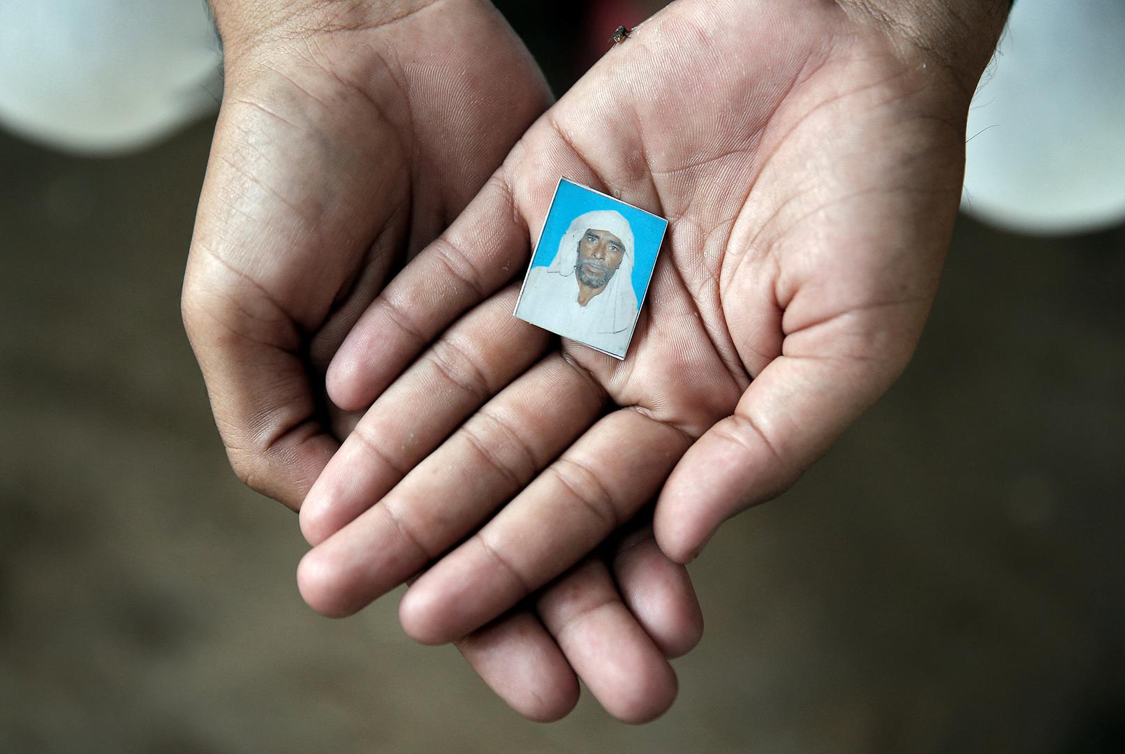 Irshad Khan holds a picture of his father, Pehlu Khan. Irshad, his brother, his father, and two others were attacked by members of a cow protection group while transporting cattle from Rajasthan to Haryana in 2017. Pehlu Khan was killed in the attack. 