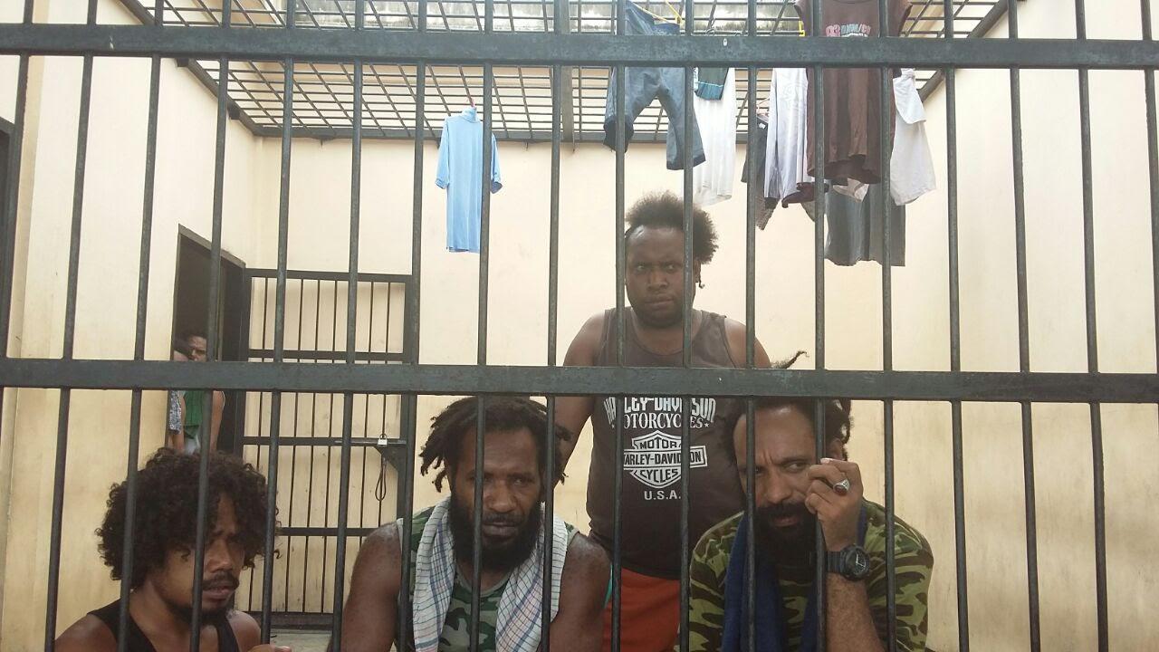 Yanto Awerkion (far left) detained in the Timika police station in September 2017 for his role in organizing a petition calling on the UN to organize a referendum in Papua. 