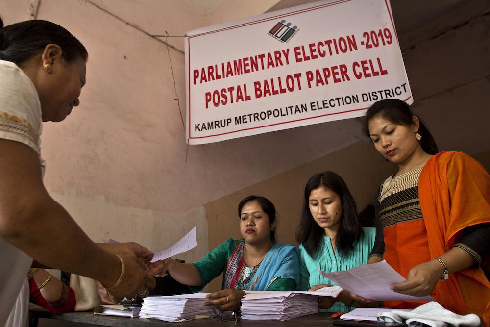देश के आम चुनावों से पहले गौहाटी, भारत  में सरकारी पदाधिकारी एक पीठासीन पदाधिकारी को डाक मत पत्र बांटते हुए, मंगलवार, 19 मार्च, 2019, कॉपीराइट.