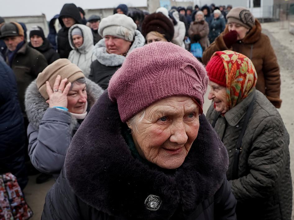 People wait at passport control after crossing the contact line between Russian-backed rebels and Ukrainian troops in Mayorsk, Ukraine, February 25, 2019. 