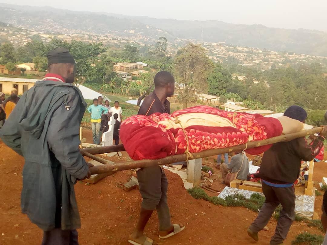 Men carry a dead body for burial in the North-West region village of Meluf, Cameroon, after government forces killed five civilian men on April 4, 2019.