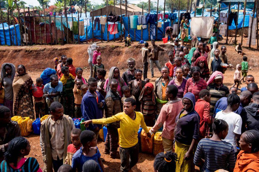Displaced Gedeo people wait in line with their containers looking for water at Kercha site, West Guji, on August 1, 2018. 