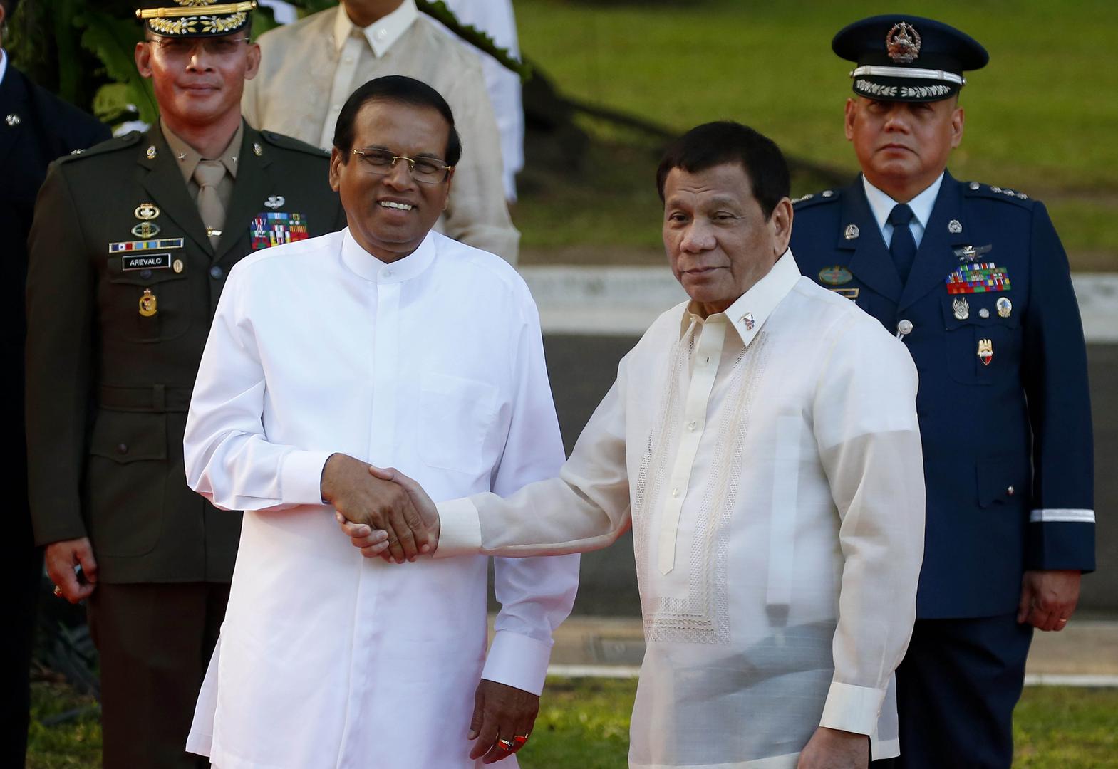 Visiting Sri Lanka President Maithripala Sirisena, left, and Philippine President Rodrigo Duterte shake hands following the welcoming ceremony Wednesday, Jan. 16, 2019, at the Presidential Palace grounds in Manila, Philippines. 