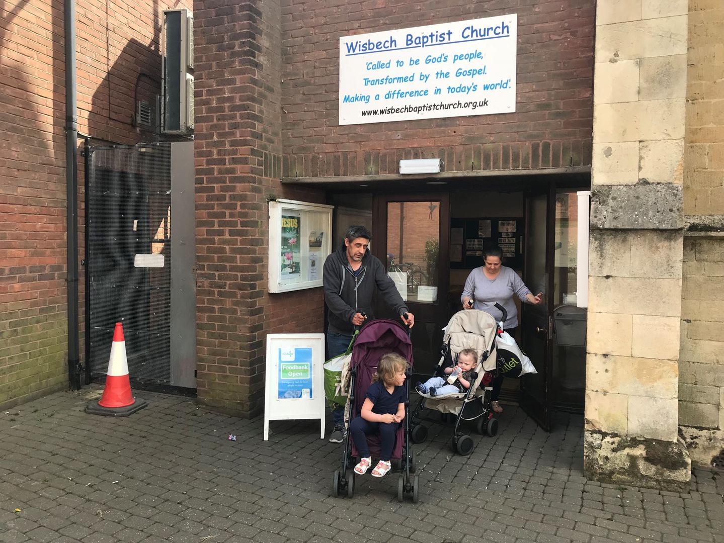 A couple and their two children leave the food bank in Wisbech, Cambridgeshire, after collecting a three day emergency supply of food, April 2019. They told Human Rights Watch the benefit cap left them unable to pay rent and afford food.