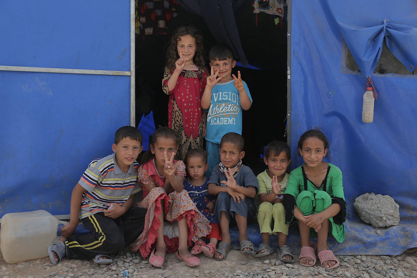 Children from families living in a tent in a camp south of Mosul housing families displaced by fighting between ISIS and Iraqi Forces, March 2017.