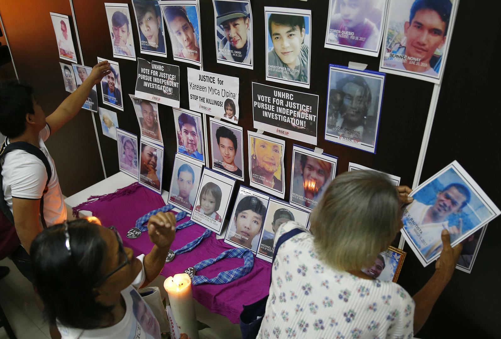 Des membres de familles de victimes de la "guerre antidrogue" aux Philippines, face à des photos de leurs proches, placés dans une salle du Conseil des droits de l'homme de l’ONU à Genève lors d’un débat consacré à ce pays en juillet 2019.