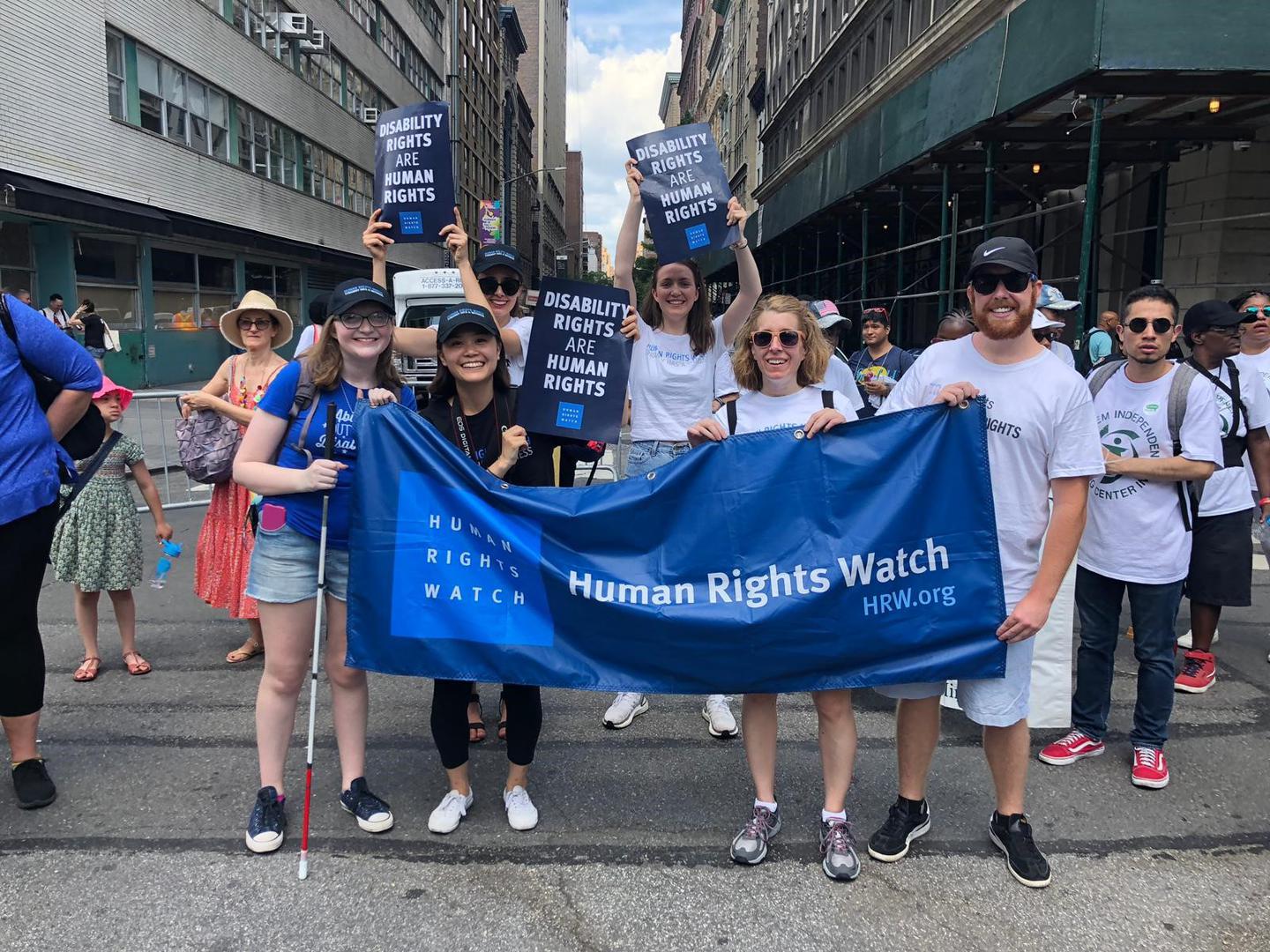 Human Rights Watch staff holds posters reading "Disability Rights are Human Rights" as they march in the Disability Pride Parade in New York City. 