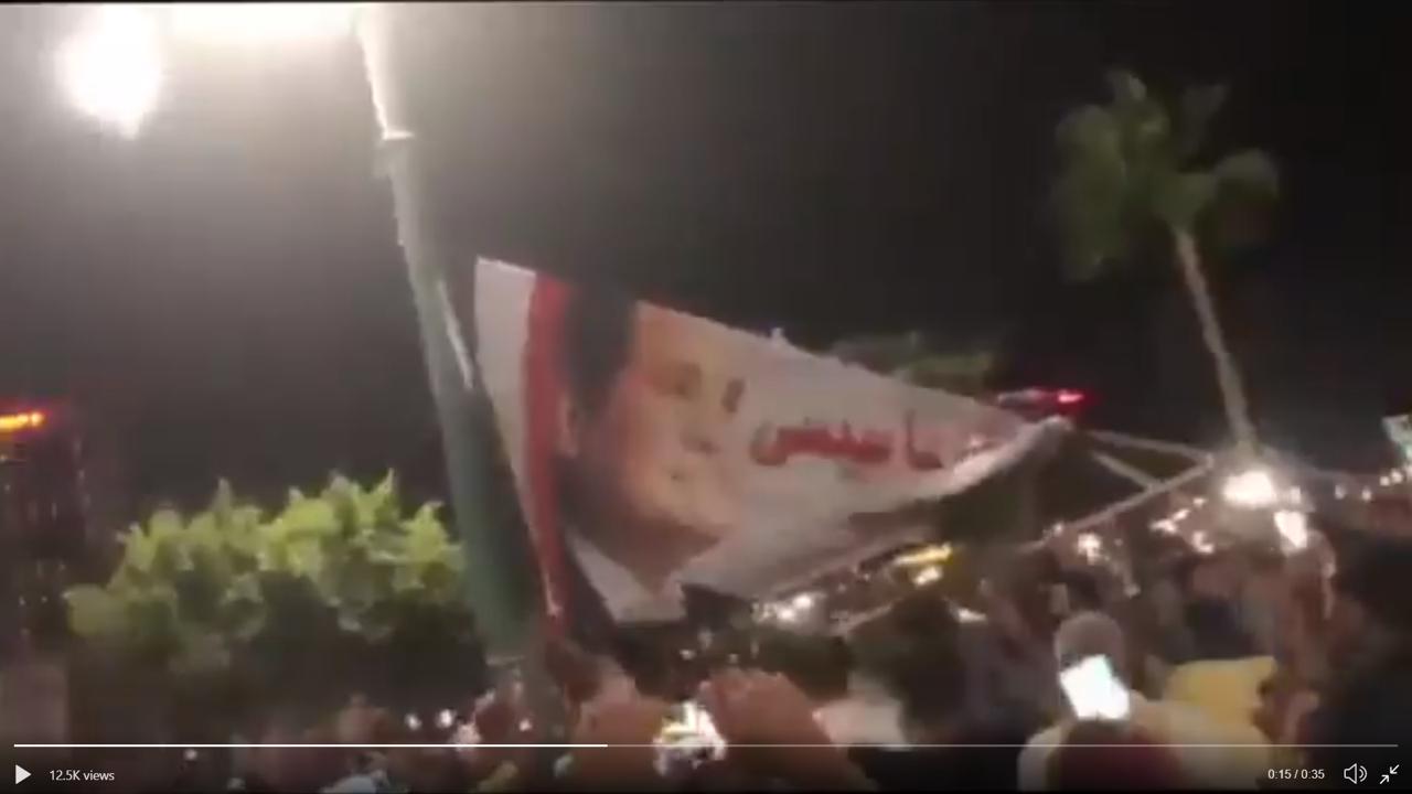 A still photo of a video circulated on social media on September 20 showing masses of anti-government protesters in the city of Damietta, North of Cairo, tearing down a big Sisi banner. © Twitter