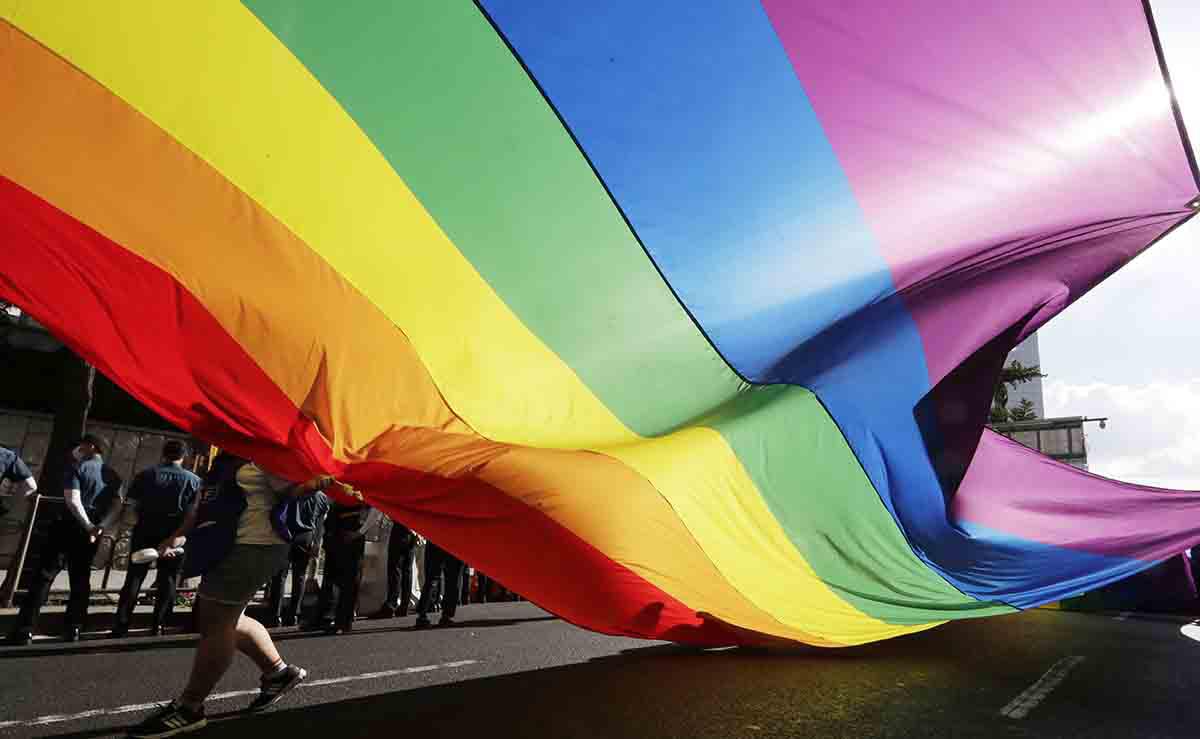 A rainbow flag is carried during a parade as a part of the Seoul Queer Culture Festival in Seoul, South Korea, Saturday, July 14, 2018. © 2018 AP Photo/Lee Jin-man