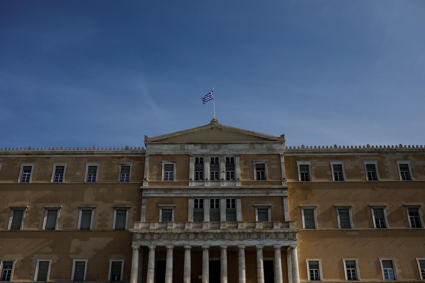 A Greek national flag flutters atop the parliament building in Athens, Greece, January 28, 2019.