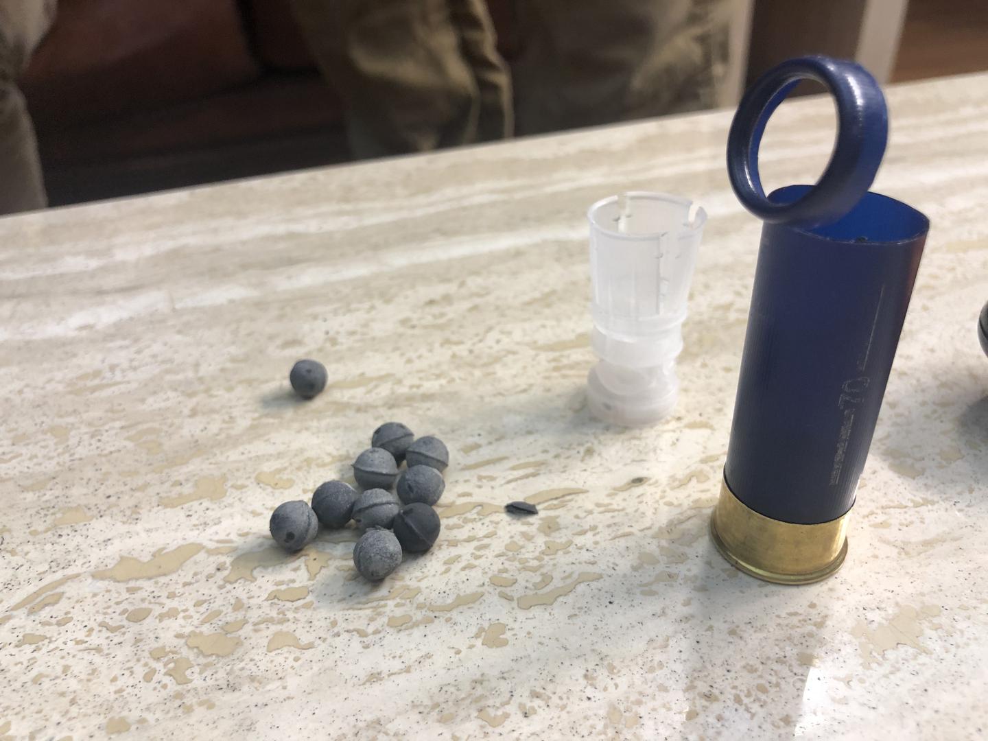 An open cartridge and 8 mm. pellets. 