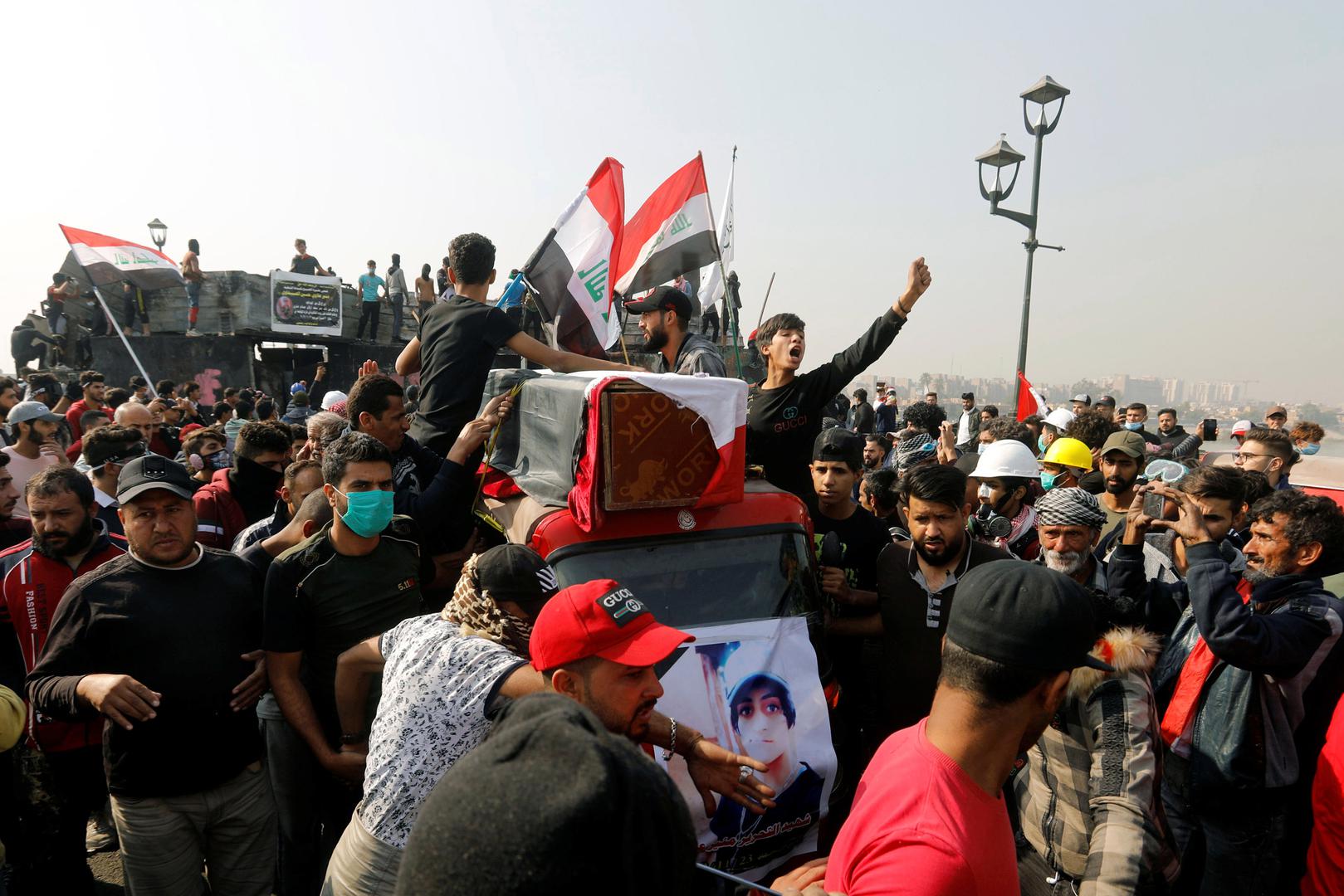 As part of a funeral procession, people transport the coffin of a protester killed at a Baghdad demonstration, November 24, 2019. 