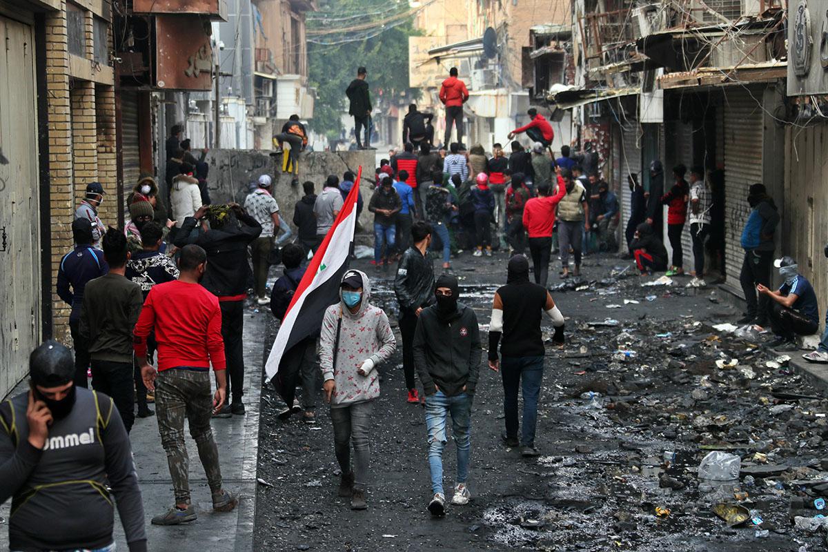 Protesters gather while security forces close River Street during ongoing anti-government protests in Baghdad, Iraq, December 10, 2019.