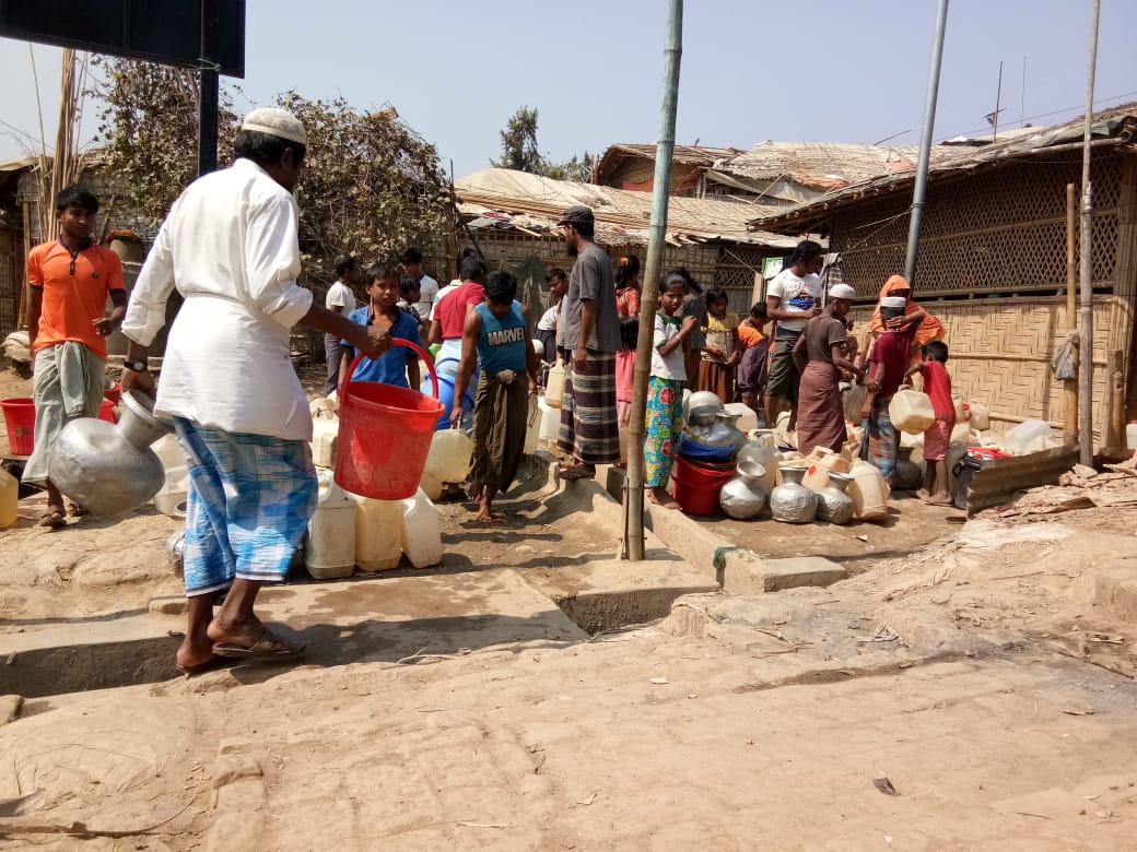 Rohingya refugees place empty jars in a line while waiting to collect water in Cox's Bazar, Bangladesh on April, 20, 2020. 