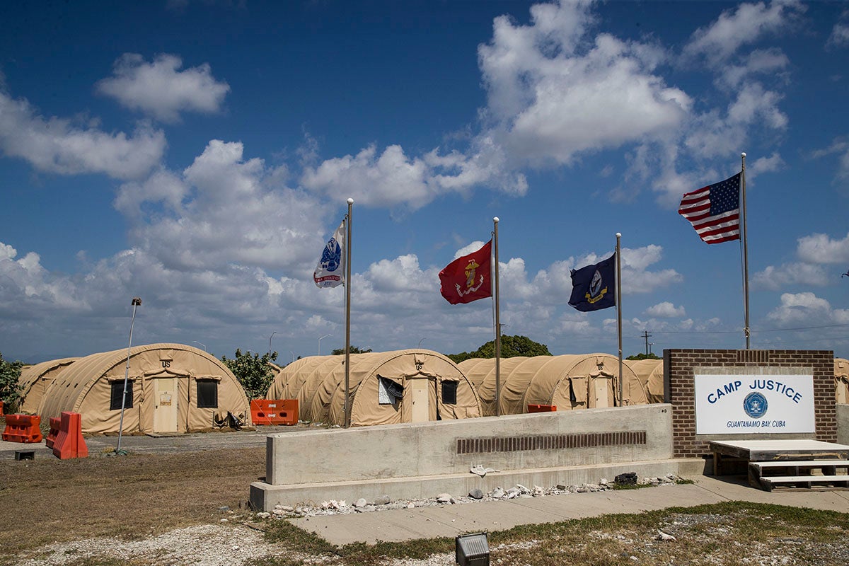 In this photo reviewed by US military officials, flags fly in front of the tents of Camp Justice, April 18, 2019, in Guantanamo Bay Naval Base, Cuba.