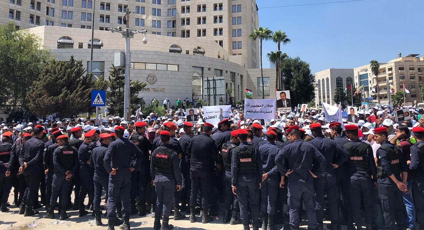 Security forces block a road as teachers protest in Amman, Jordan, September 5, 2019. 