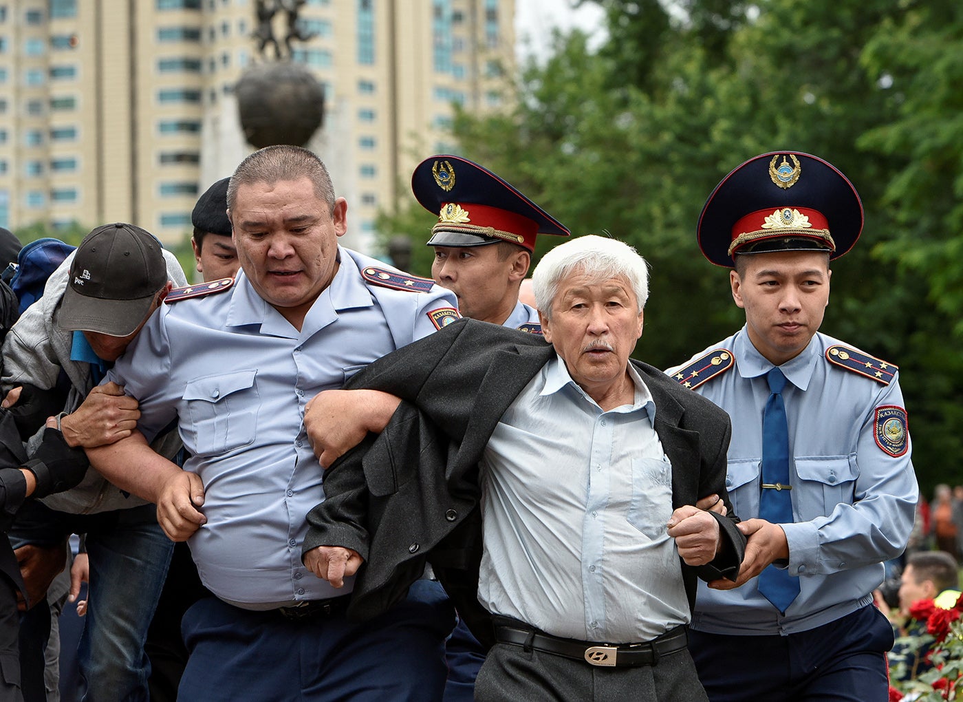 Police officers detain an opposition supporter during a protest around presidential elections, in Almaty, Kazakhstan, June 9, 2019.