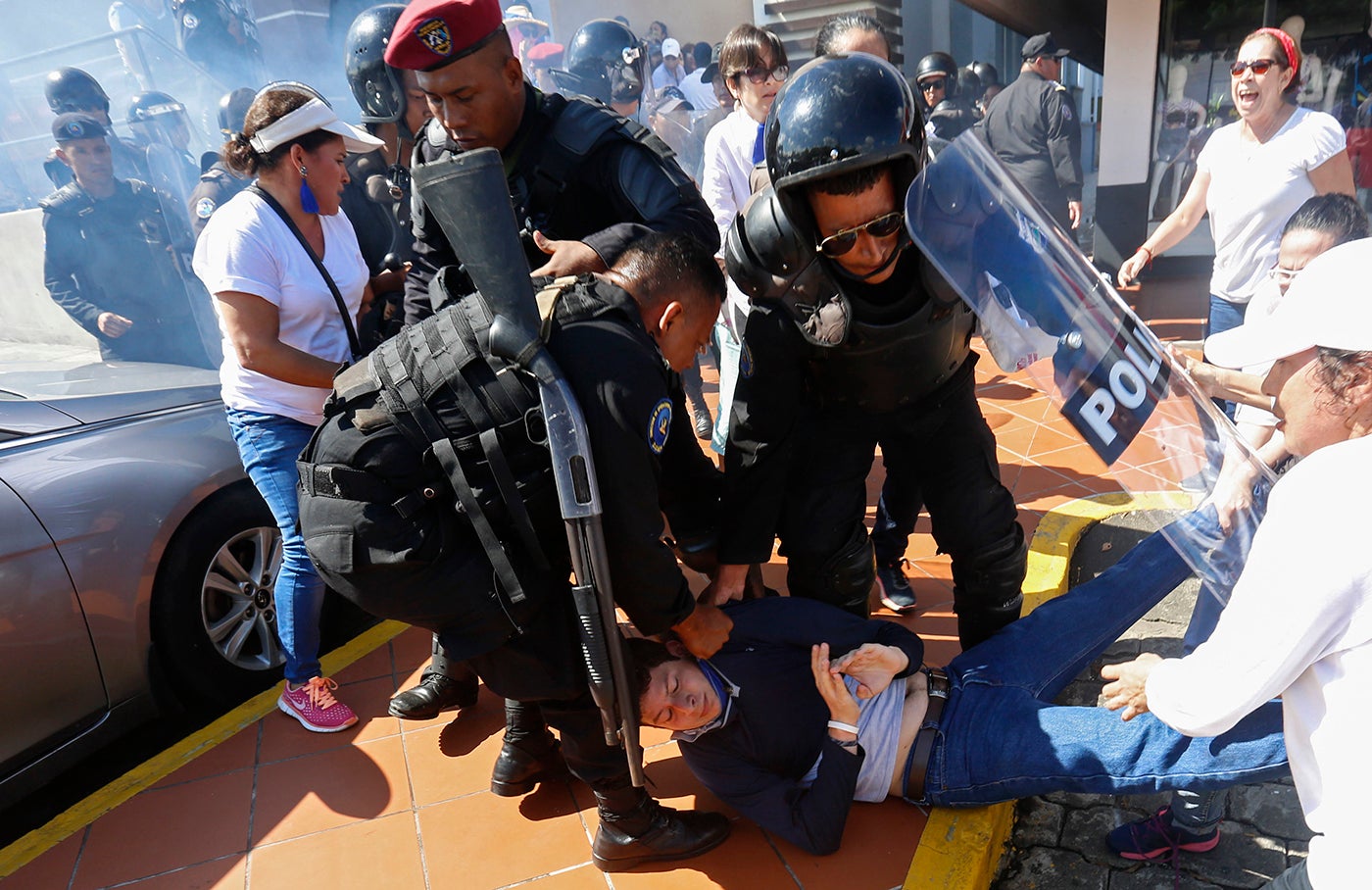 An anti-government protester is dragged away and arrested by police as security forces disrupt an opposition march coined "United for Freedom" in Managua, Nicaragua, Sunday, Oct. 14, 2018.