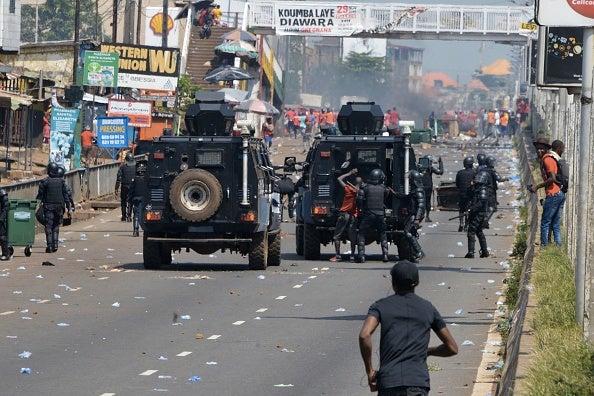  Police officers arrest a man during a protest against a proposed new constitution in Conakry, Guinea on November 14, 2019.