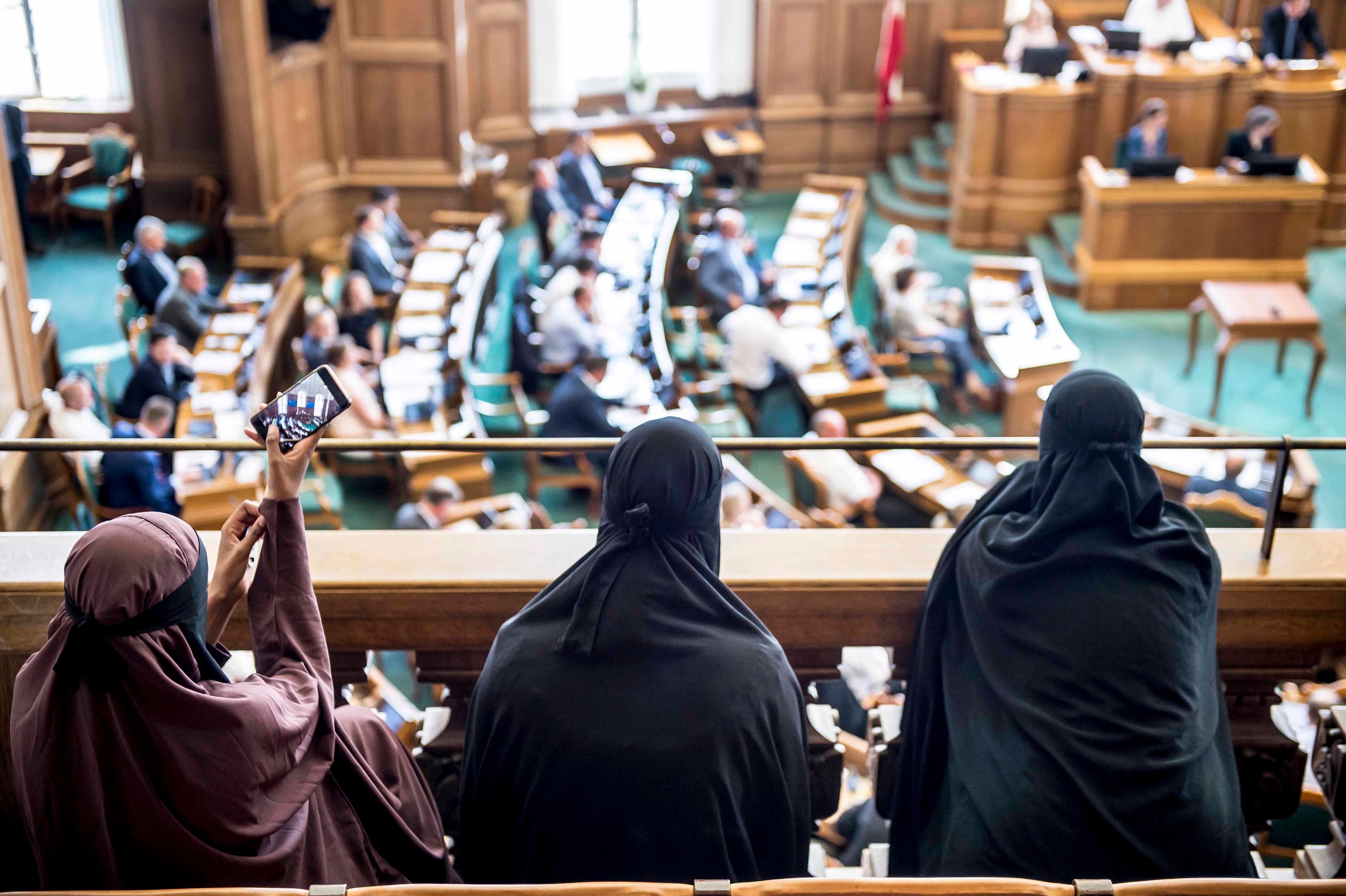 Women wearing the Islamic veil, the niqab, sit in the audience seats of the Danish Parliament, at Christiansborg Castle, in Copenhagen, Denmark, May 31, 2018. Denmark joined some other European countries in deciding to ban garments that cover the face, in