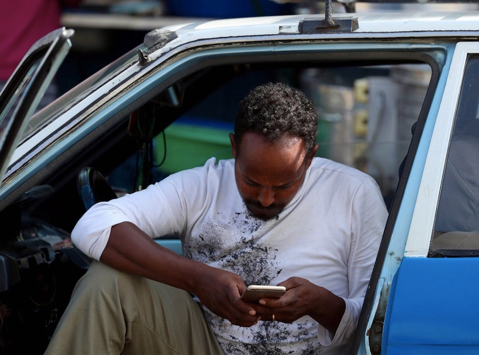 Mimiyo Fikadu, 38, taxi driver, browses through the internet using his Ethio-telecom service as he waits for his customers in Addis Ababa, Ethiopia, November 12, 2019. REUTERS/Tiksa Negeri