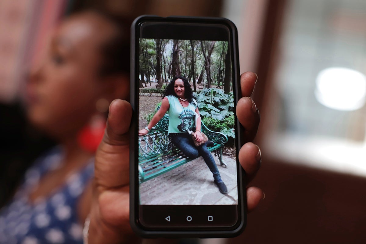 A transgender woman shows a photograph of Camila Díaz, whom she met while migrating to the US, where they both turned themselves in to immigration authorities. Both women were eventually deported.