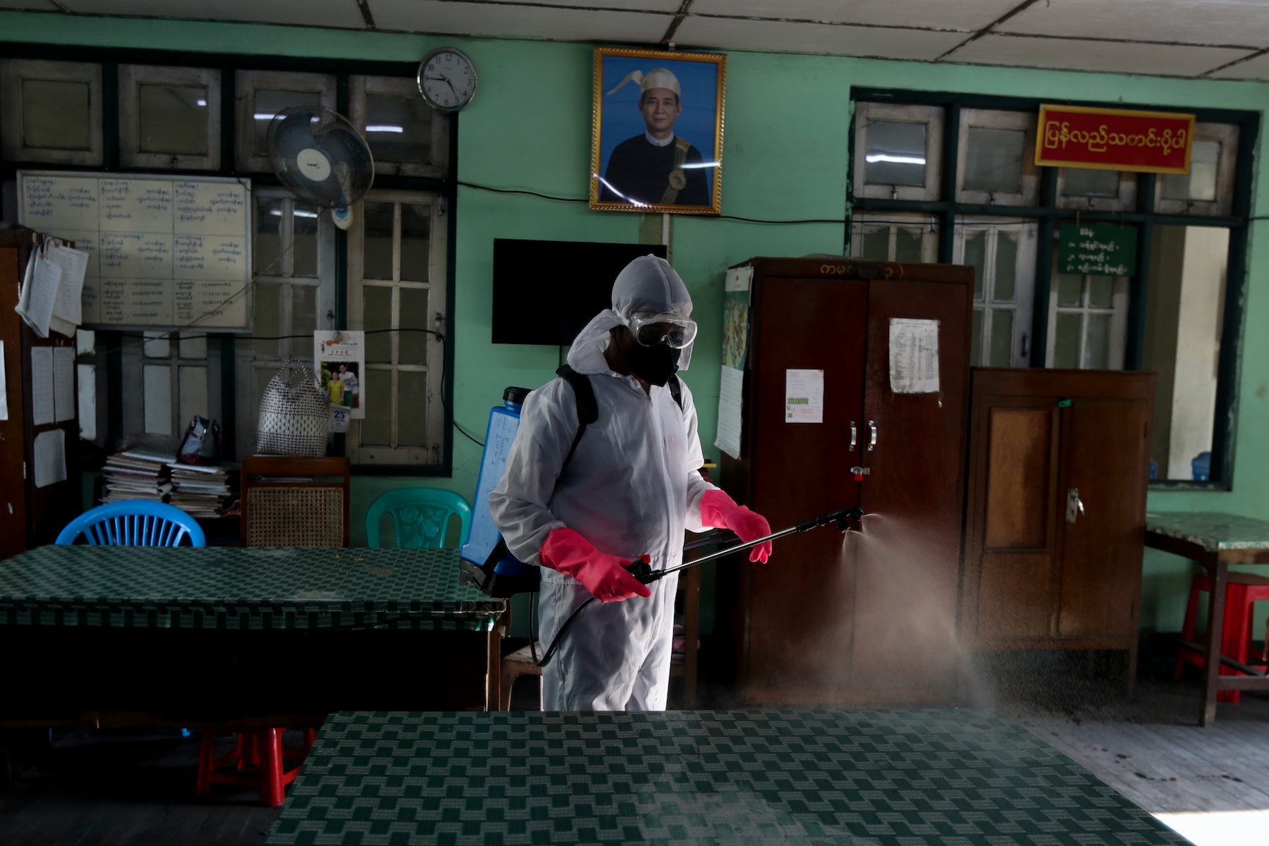 A city worker disinfects government offices as a preventive measure against the coronavirus, Yangon, Myanmar, March 25, 2020.