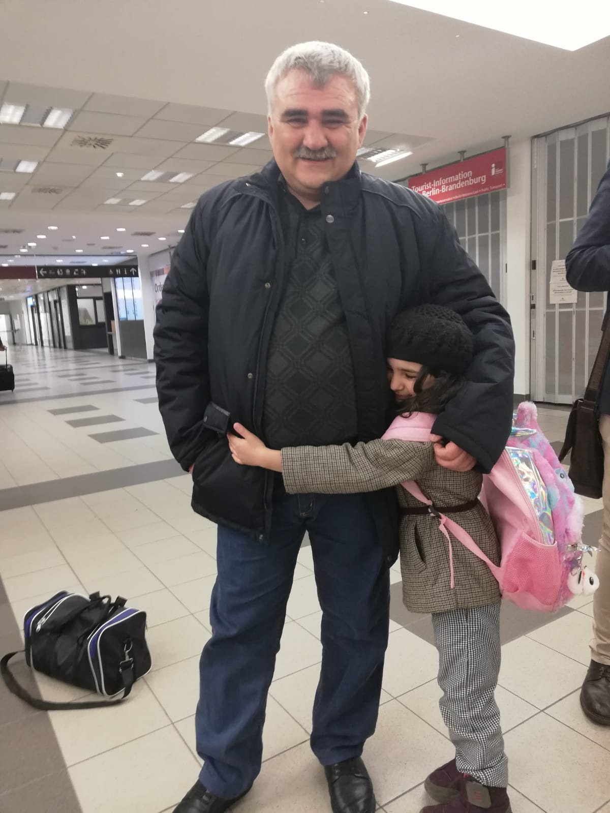 Journalist Afgan Mukhtarli rejoins his daughter in a Berlin airport following his release from prison in Azerbaijan, March 17, 2020.