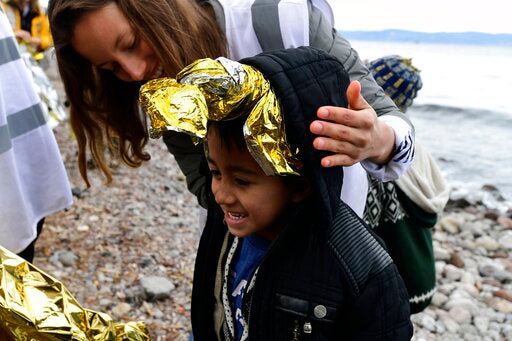 A boy from Afghanistan arriving on the Greek island of Lesbos after crossing the Aegean sea from Turkey, on Friday, Feb. 28, 2020. 