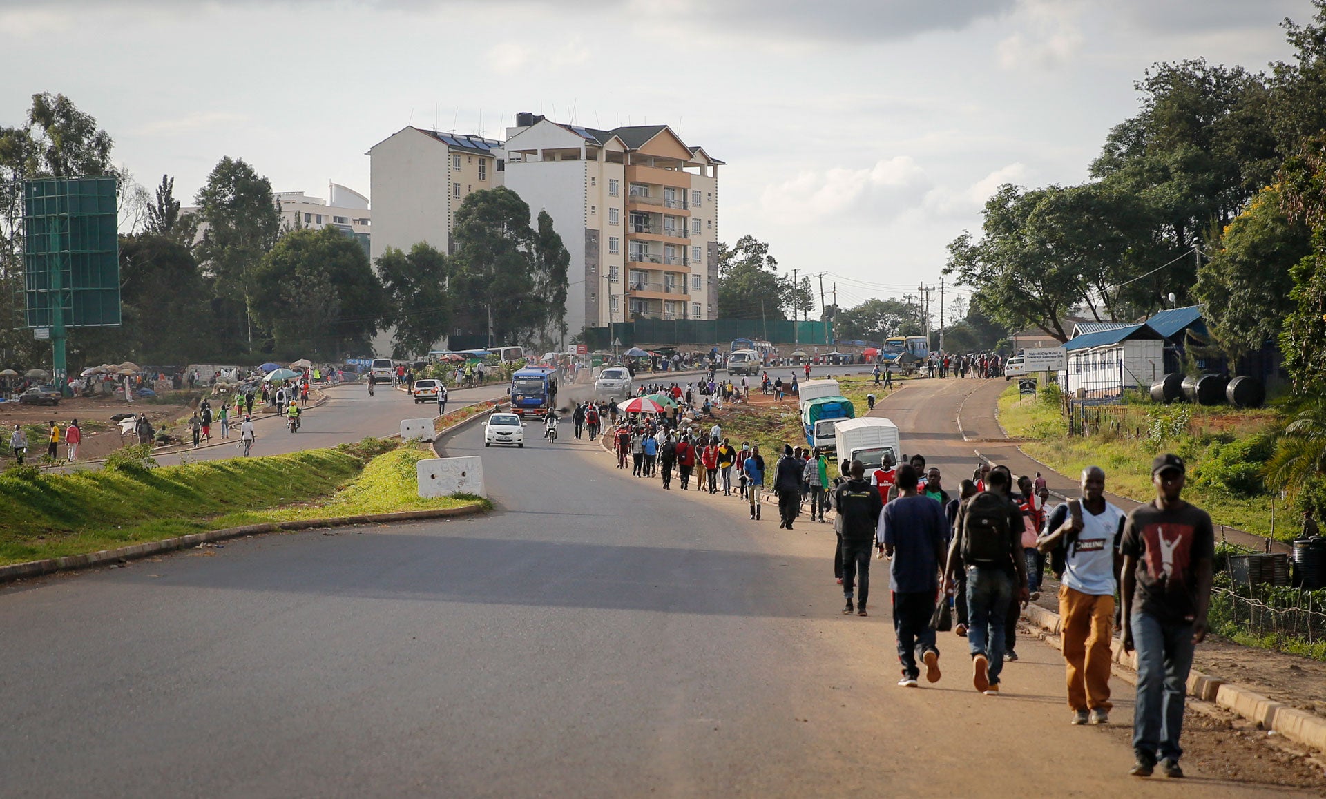 Kenyans make their way home before the daily dusk-to-dawn curfew in Nairobi, Kenya, April 6, 2020.